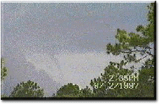 [August 2nd, 1997.  A funnel
cloud look-a-like associated with
two colliding gust fronts. It's
actually just scud.]